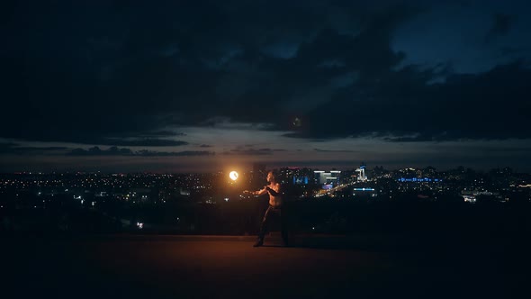 Young Blond Male Does Tricks with Fire, Male Breaths Out Large Stream of Fire Making Fireball.