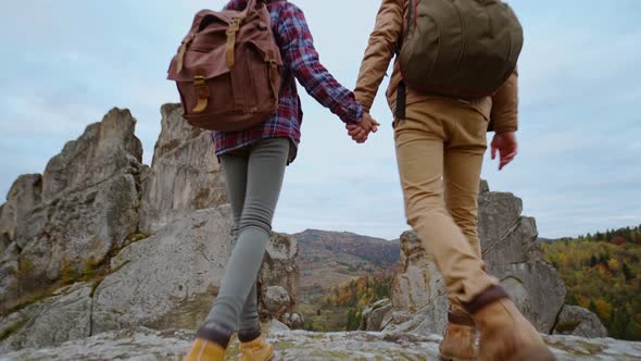 Couple Holding Hands Hiking Outdoors at Romantic View on Rocky National Park Tustan Ukraine