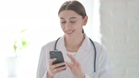 Portrait of Female Doctor Browsing Internet on Smartphone