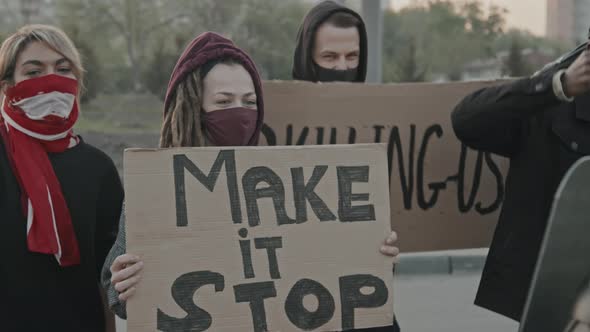 Slowmo of People Protesting before Riot Policemen