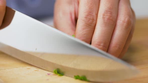 Woman Chopping Parsley with Kitchen Knife at Home