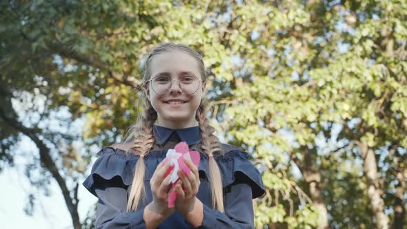 The Girl Blows Flower Petals From Her Hands