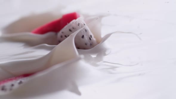 Tossing cut dragon fruits in yoghurt. Slow Motion.