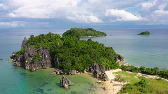 Nature Landscape: Sandy Tropical Beach with Crystal Clear Sea. Rocks and Tropical Beach in Caramoan