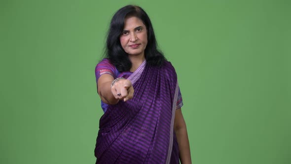 Mature Beautiful Indian Woman Pointing at Camera While Wearing Sari Traditional Clothes