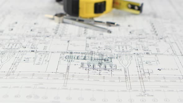 On the Table Lies a Divider, Measuring Tape and Drawing. Close Up