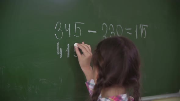 Doing Sums on Chalkboard 