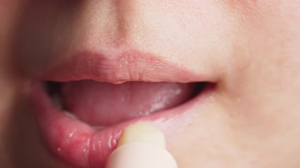 Anonymous Female Applying Balm in Morning