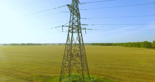 Vertical Movement Flight Near High Voltage Electricity Tower and Power Lines at Green and Yellow