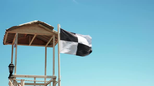 Flag prohibits swimming in sea due to water sport area. alt