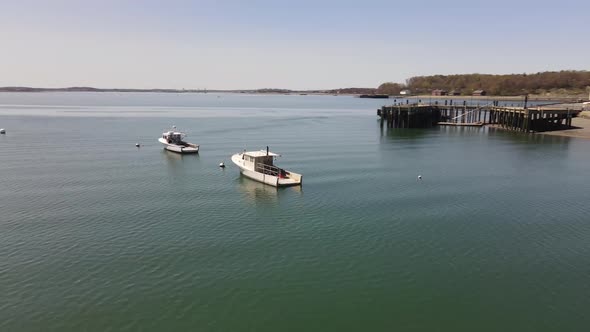 Drone circle pan of a lobster boat in Hull Bay near Hull Gut. Saltwater, fishing vessel.  Aerial