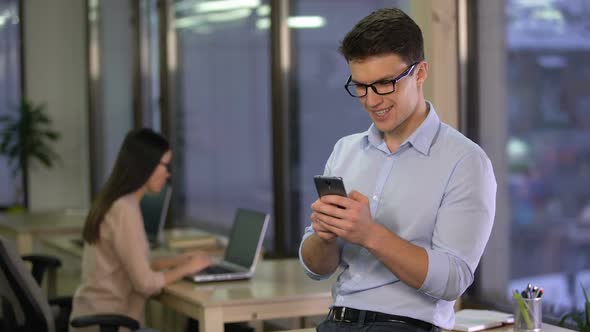 Office Employee Chatting in Social Media Messenger on Smartphone, Communication