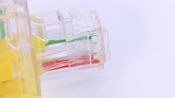 Close up shot of ethernet cable of yellow plastic rotating on white surface, Macro shot from above i