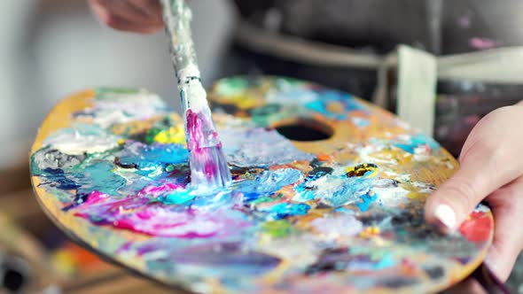 Closeup Professional Painter Hands Mixing Color Paint on Palette Creating Amazing Picture