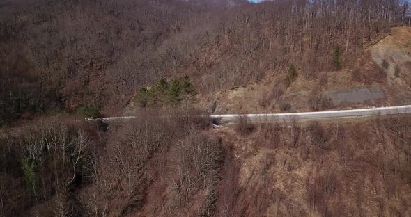 Aerial Autumn Road From Above View of Cars on a Zig Zag Road. Season Forest Road Landscape. Mountain