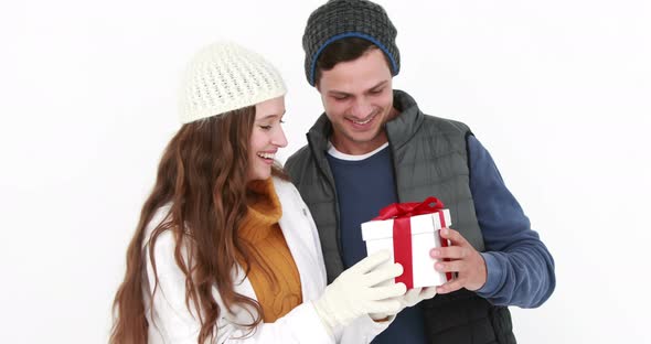 Casual couple in warm clothing holding gift 4k