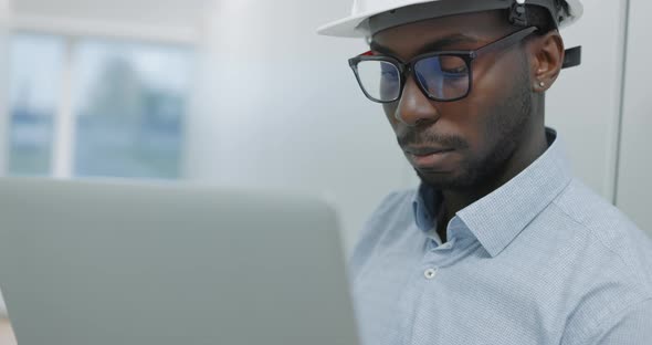 Man Using a Laptop While Working in a Server Room