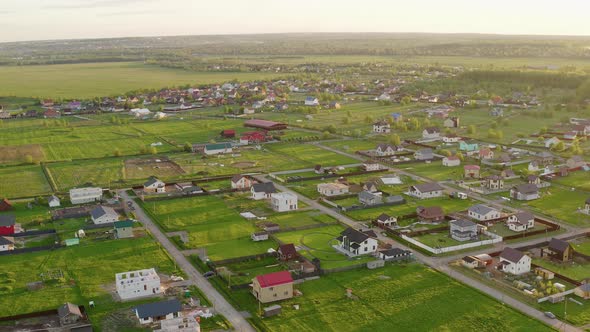 Drone flying above fields and village