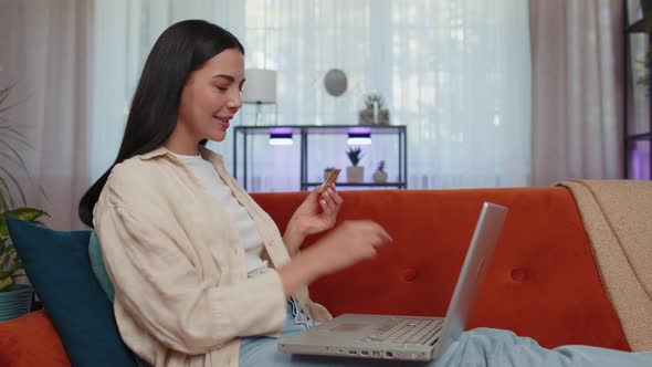 Young Woman Using Credit Bank Card and Laptop Transferring Money Purchases Online Shopping