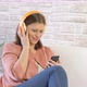 woman dressed in jeans dancing and listening music with headphone - VideoHive Item for Sale