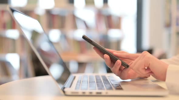 Woman Working on Smartphone and Laptop Close Up