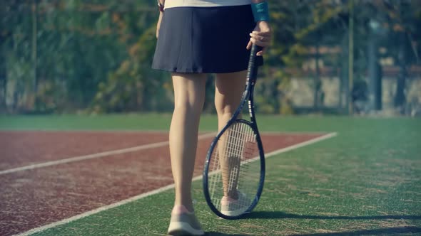 Female Tennis Player Preparing To Set Ready To Serve Ball. Girl With Rocket Playing On Tennis Court.