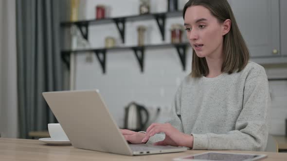 Surprised Young Woman Feeling Shocked on Laptop at Home 