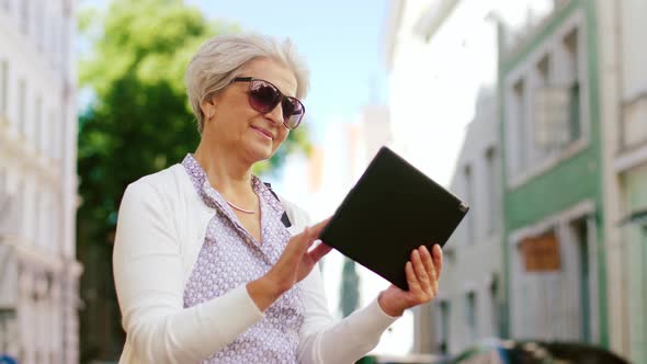Senior Woman with Tablet Pc on City Street