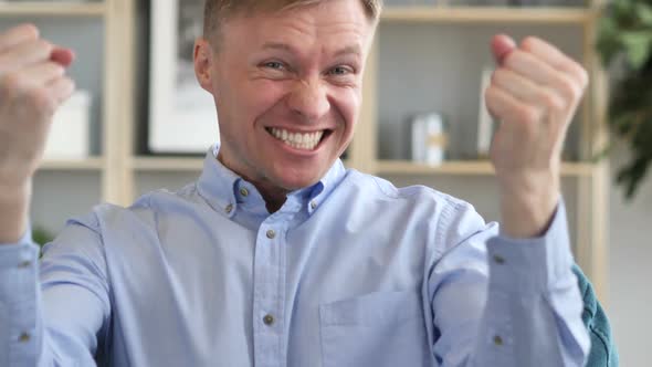 Businessman Celebrating Success Gesture in Office