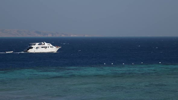 White Tourist Boat in the Sea Near Reef