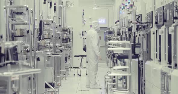 Workers in clean suits in a Semiconductor manufacturing facility