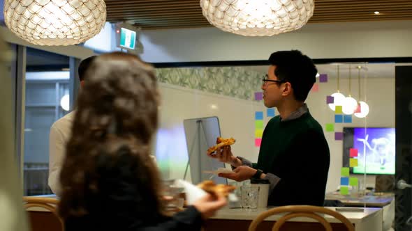 Business executives eating pizza in office cafeteria 4k