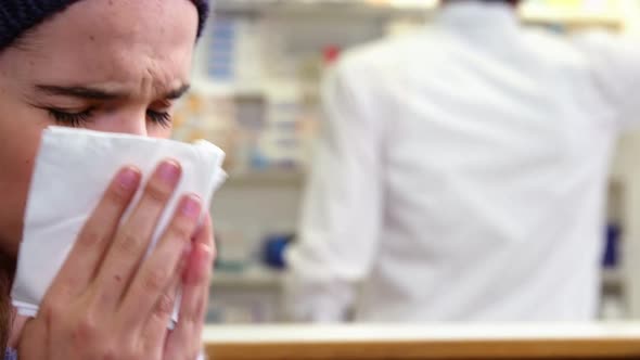 Customer covering her nose while sneezing