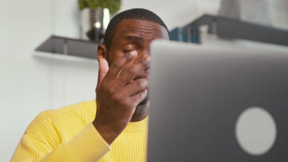 Young attractive man holding video conference remotely from home office