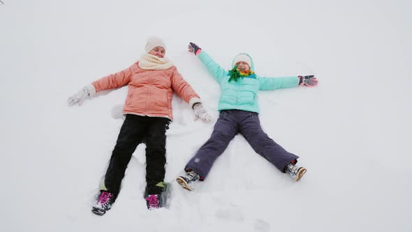 Winter Activity - Mom and Daughter Have Fun in the Snow