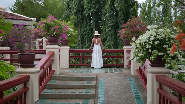 Woman Stands on Terrasse, Camera Moves From the Back To Her, She Looks Forward