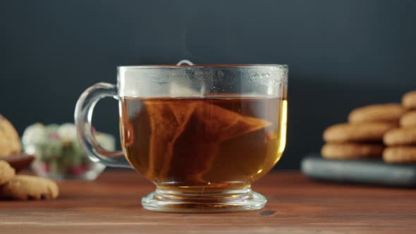 Freshly Brewed Cup of Black Tea on a Wooden Table Tea Ceremony Process Fast Food Water Pouring to