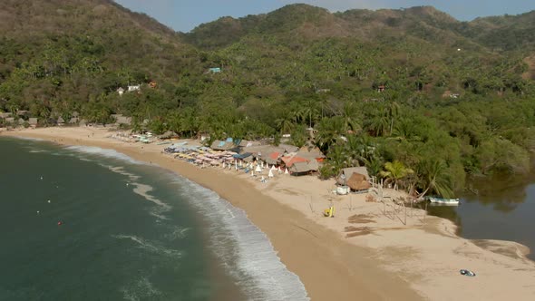 Waterfront Restaurants On Sandy Beach Of Yelapa In Jalisco, Mexico On A Sunny Summer Day. aerial