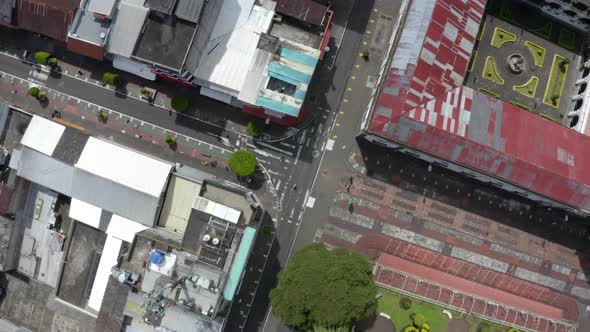 Aerial top view over a small crossing with mostly people crossing the street