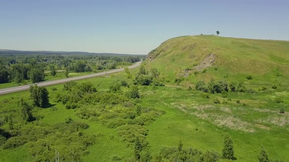 Aerial: Flying Over the Highway Among the Mountains