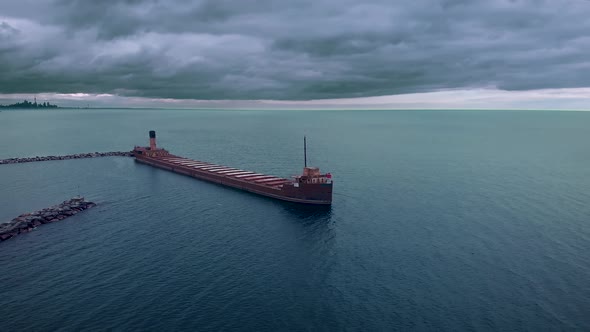 Cinematic aerial view of an abandoned old shipwreck, Lake Ontario, Canada