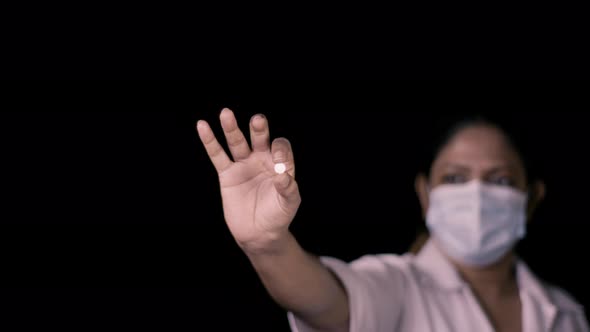Nurse Holds Round White Pill
