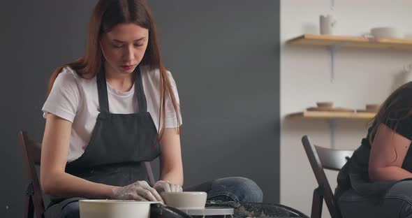 Young Woman in Pottery Studio Using Pottery Whee