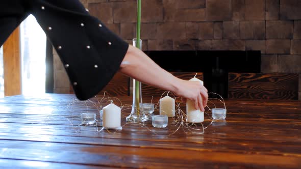 Woman Standing Decoration Candles on Table for Holiday Dinner