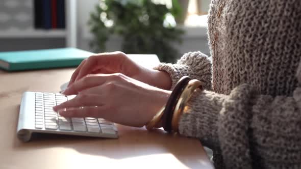 Young Blogger at Work Typing her New Post