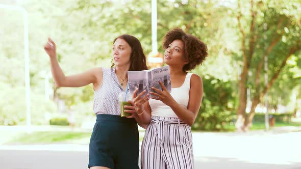 Women with City Guide and Drinks on Street 36