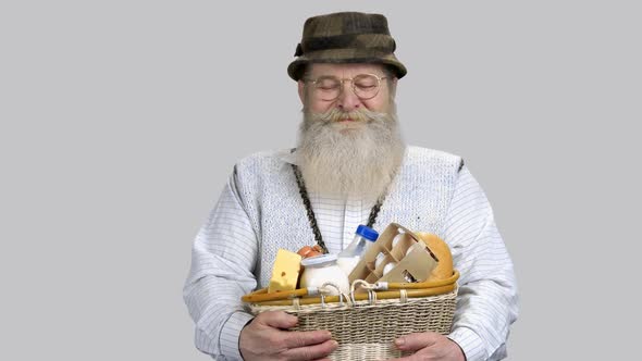 Portrait of Happy Retired Aged Grandpa with Straw Basket of Grocery Food