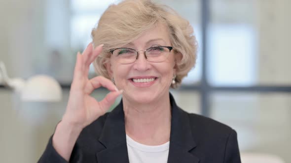 Portrait of Old Businesswoman Showing Okay Sign
