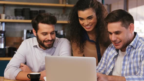 Friends using laptop