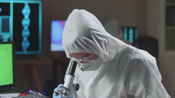 Asian Doctor In Protective Suit Working With Mock Up Green Screen Computer Display In A Modern Lab